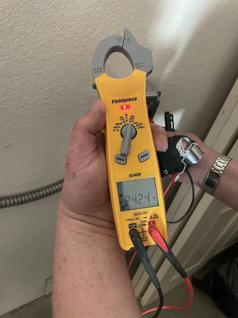 Voltage testing with clamp meter during Recessed Lighting Installation in Jefferson